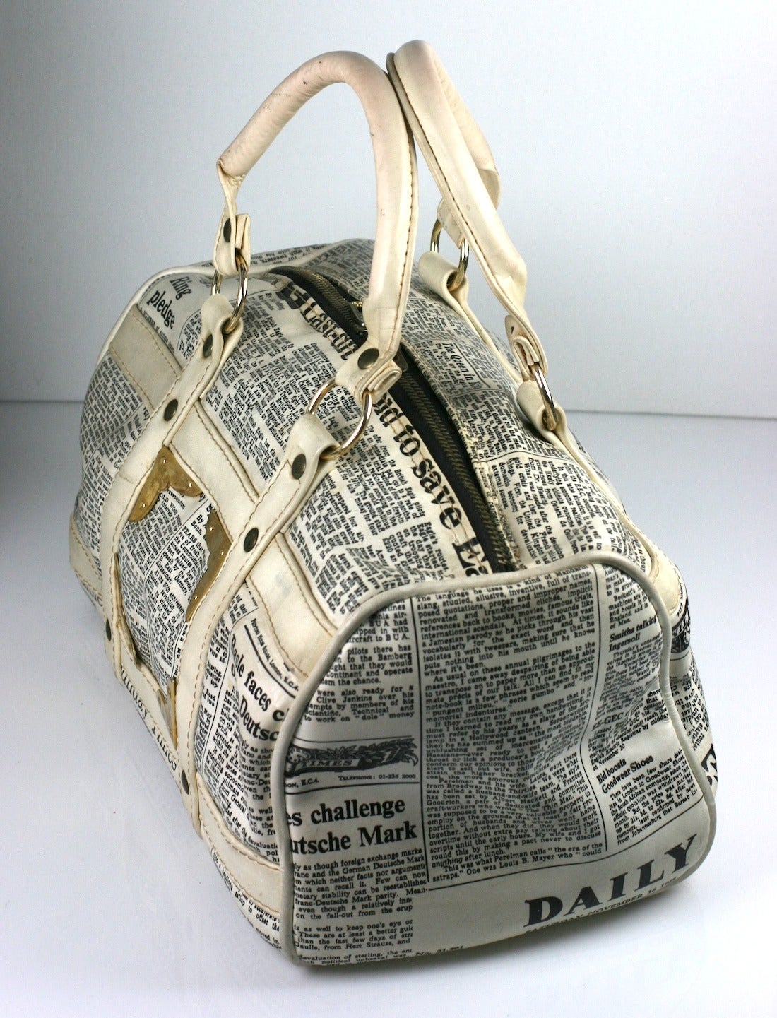 Unusual vinyl satchel made in the 1960's with newsprint articles from the UK. One article is from the 