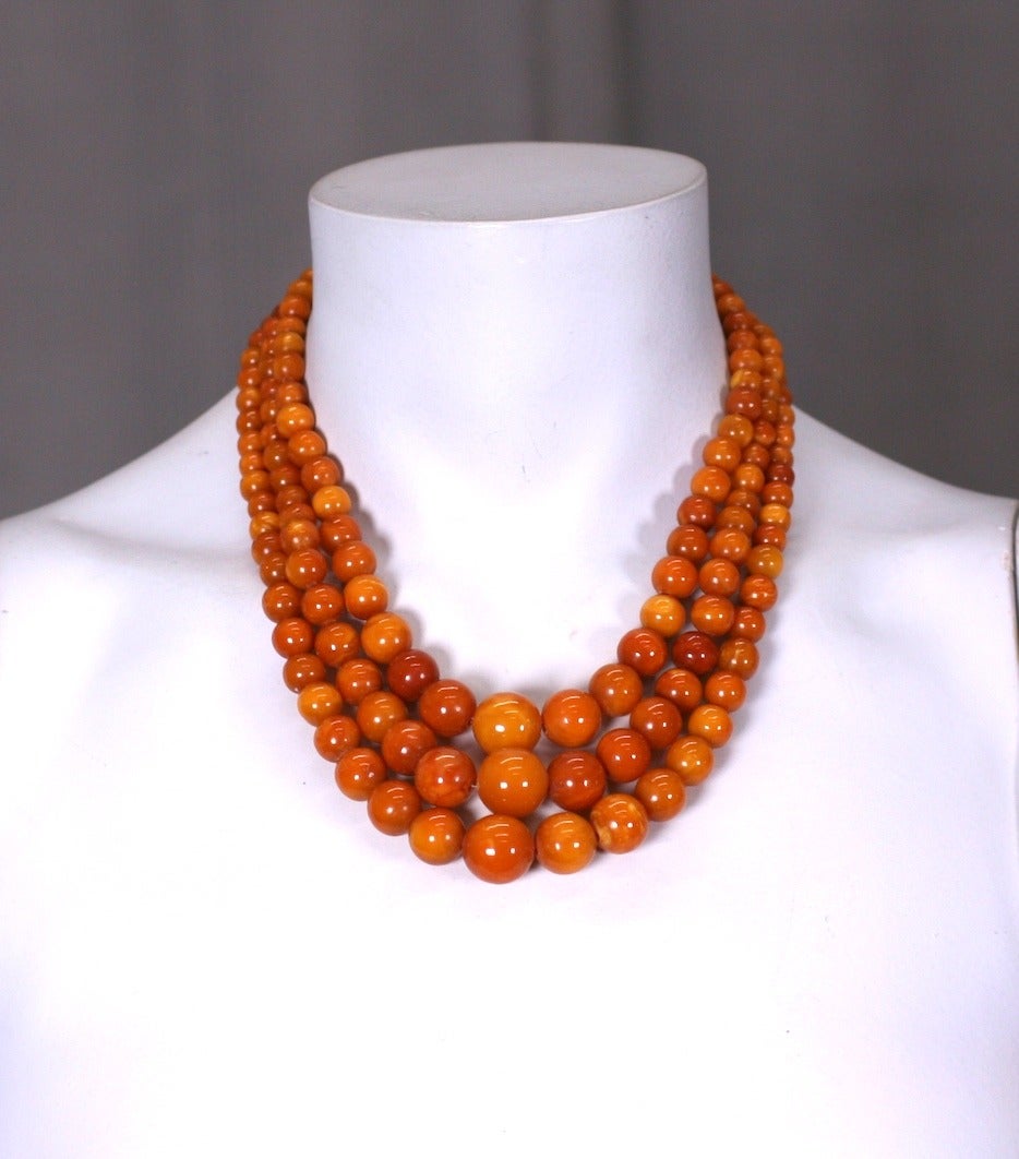 Lovely 3 Strand Natural Amber necklace of graduated beads attached to a Sterling Deco form clasp. 1930's. 
16