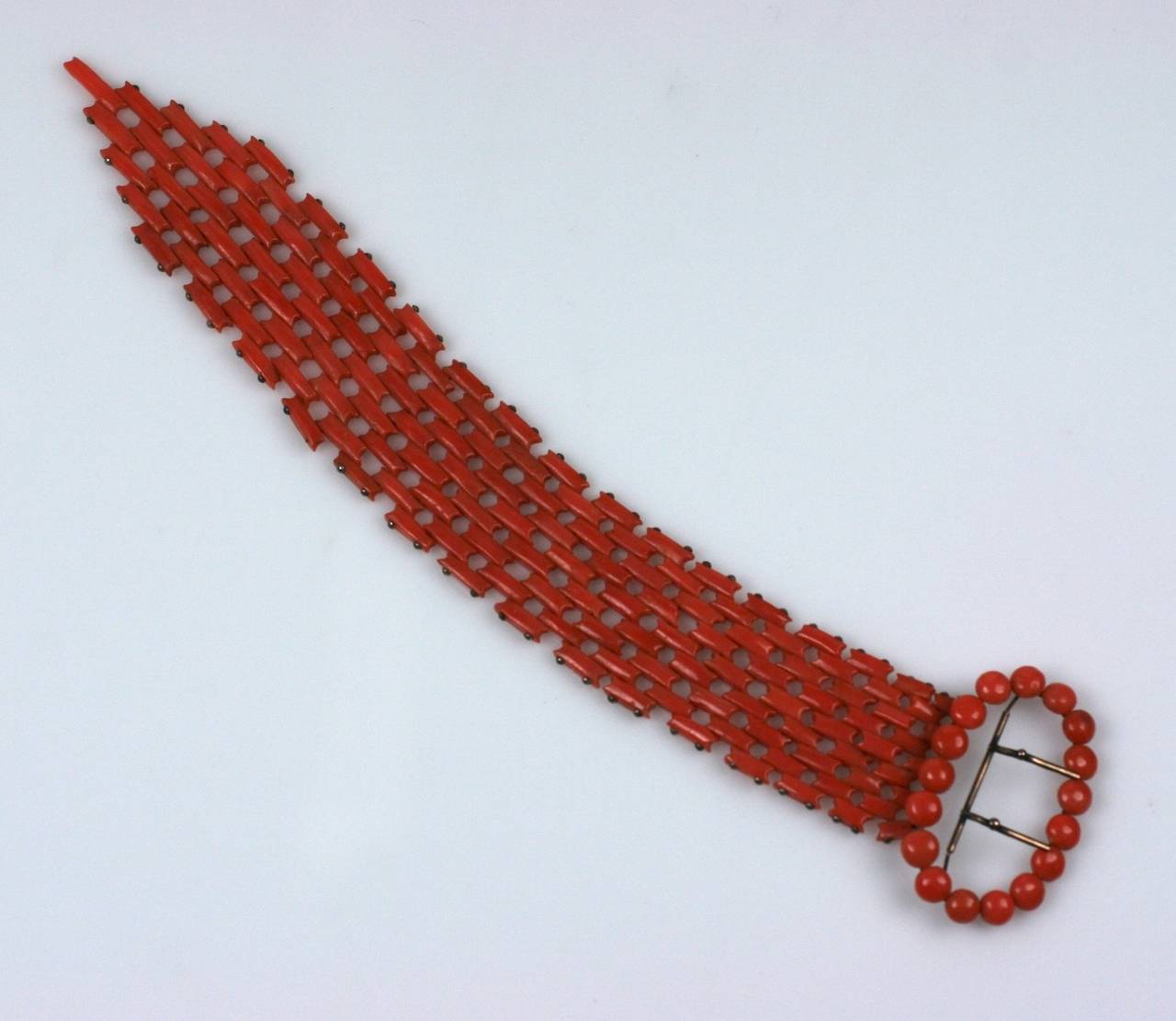 Unusual hand carved Victorian coral link bracelet with buckle motif. "Buckle" is composed of  tablet coral beads and the links are toggled together by gold pegs. Very striking scale. 1870's Italy. Excellent condition. 
9.5" x