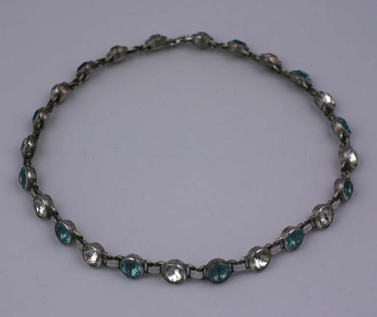 Elegant choker set in silvered metal with bezel stone large stone links. Pastes are bezel set into heavy close backed settings and alternate between crystal and blue zircon tones. Unusual colorations. 1950's USA.  15 x 3/8
