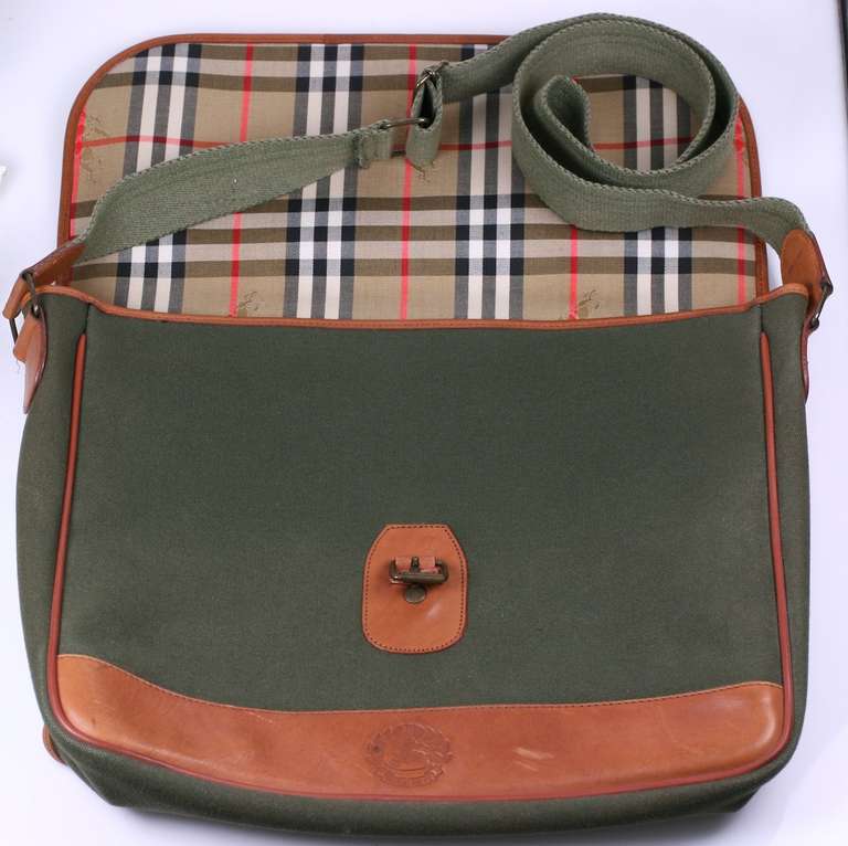 Vintage Burberry book bag for men or women. Heavy cotton duck with leather trim. Signature plaid lining. Made in Italy for Burberry UK. Very Good condition.
11