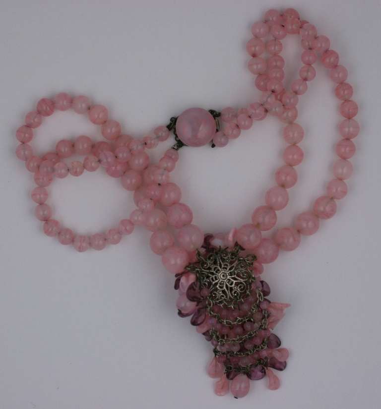 Louis Rousselet pale pink and amythest pate de verre necklace composed of 2 strands  of graduated beads with a large petal strewn frontpiece. The dozens of handblown glass petals are attached to a filigree backing and swag chains below for