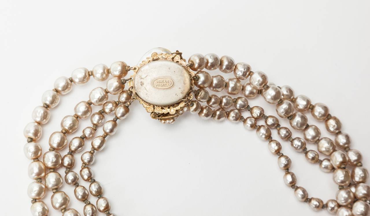 Miriam Haskell Classic four strand (two size) signature baroque faux pearl necklace. Oval clasp of signature Russian gilt filigrees, vari sized oval button pearls with round and rice pearls . Excellent condition. 1950's USA. 
Length 14.50