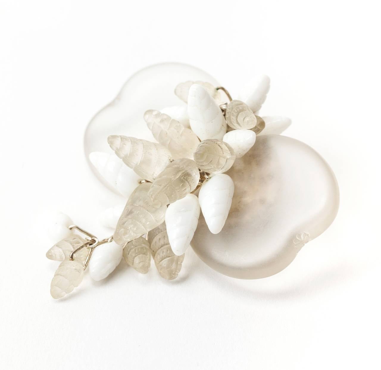 Miriam Haskell's dangling sea shell brooch with 3 different kinds of glass...frosted beach glass, molded milk glass and frosted camphor glass  shells. The brooch set in silver gilt signature filigree. Excellent condition.
W 2.25