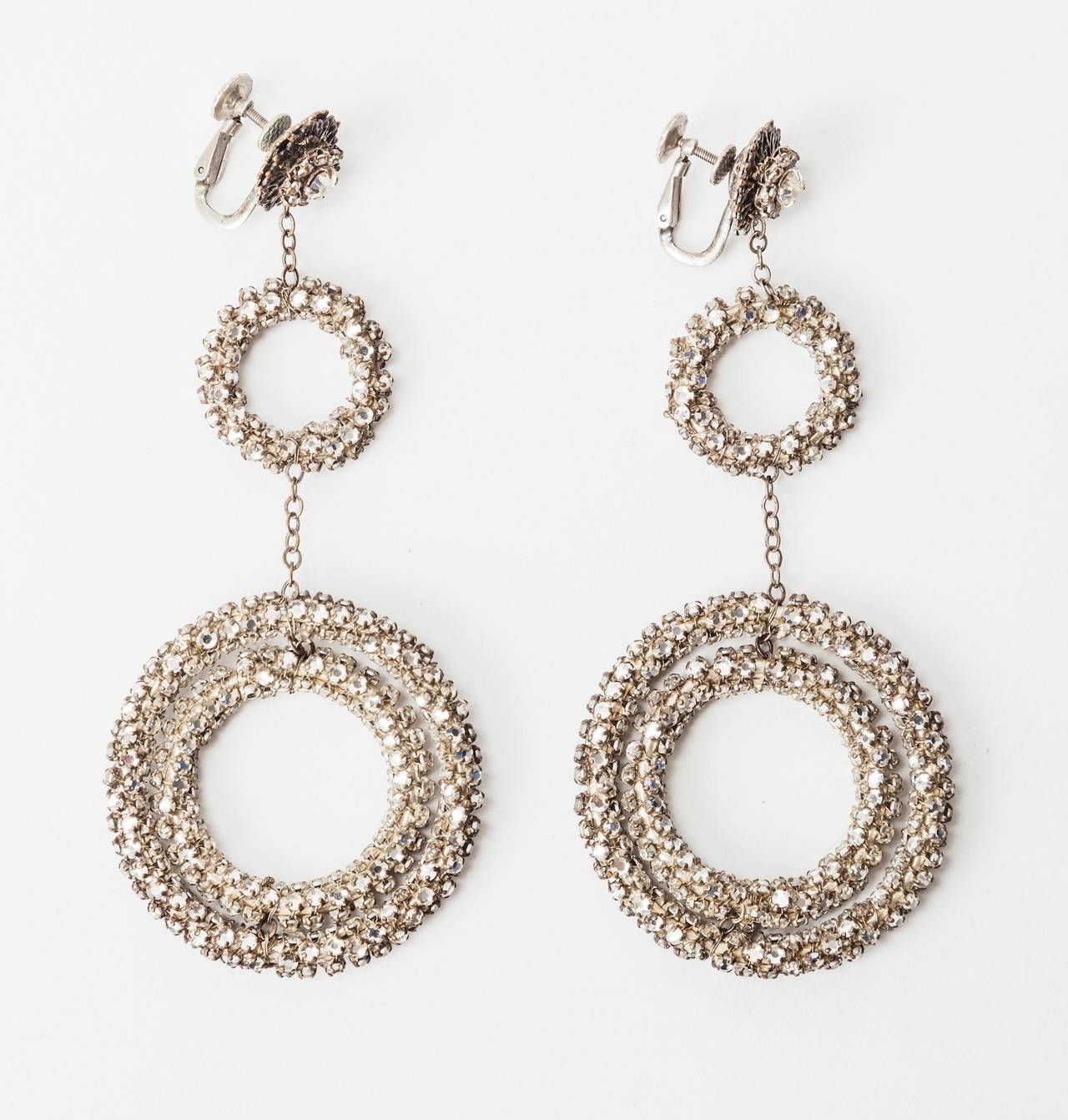 Unusual and dramatic Miriam Haskell  gyroscope triple hoop earrings. Set in Signature silver gilt and filigree metal which is wrapped and intricately hand sewn with crystal rose montees and larger crystal pastes. Exceptional quality and striking in