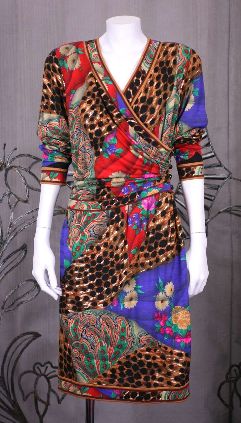 Leonard of Paris soft silk/wool (30/70%)  blend jersey wrap dress with printed gold highlights.. Signature melange of animal and floral prints with matching banding. Shoulder pads. Wrap is held by jet buttons on the side, and zipped inside on the