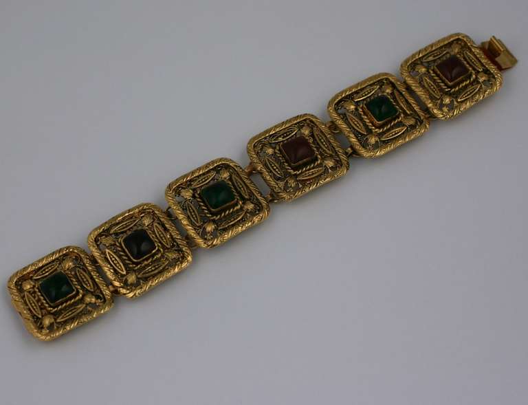  Maison Gripoix for Chanel Byzantine style articulated link bracelet, handmade and composed of six gilt filigree links with ruby and emerald rectangular poured glass cabochons. Unsigned.
Marked: Made in France. 1980's France. 8