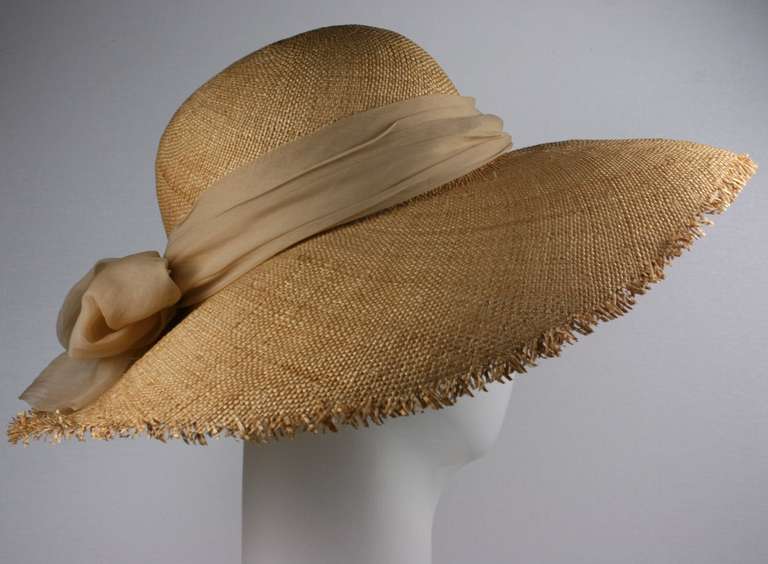 Madame Paulette Haute Couture natural woven hand fringed straw  hat trimmed with a cafe au lait chiffon scarf and bow.

interior band 21.50