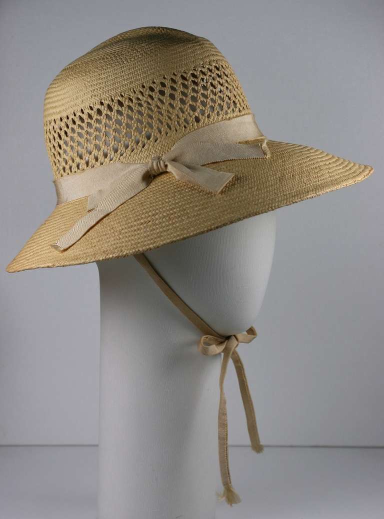 Madame Paulette Haute Couture natural lattice weave straw hat. Styled as a modified pith helmet with ivory grosgrain band and under the chin ties.

inside band 21.35