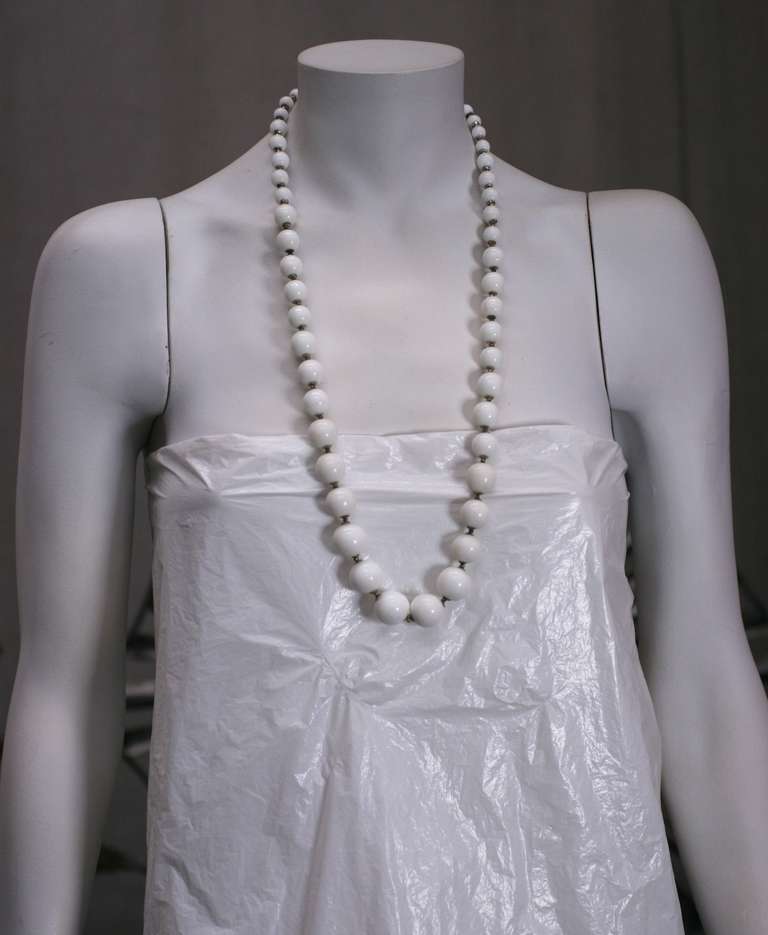 Miriam Haskell Milk Glass long necklace of graduated beads with silver toned caps and spacers. Excellent condition. 
Length 30