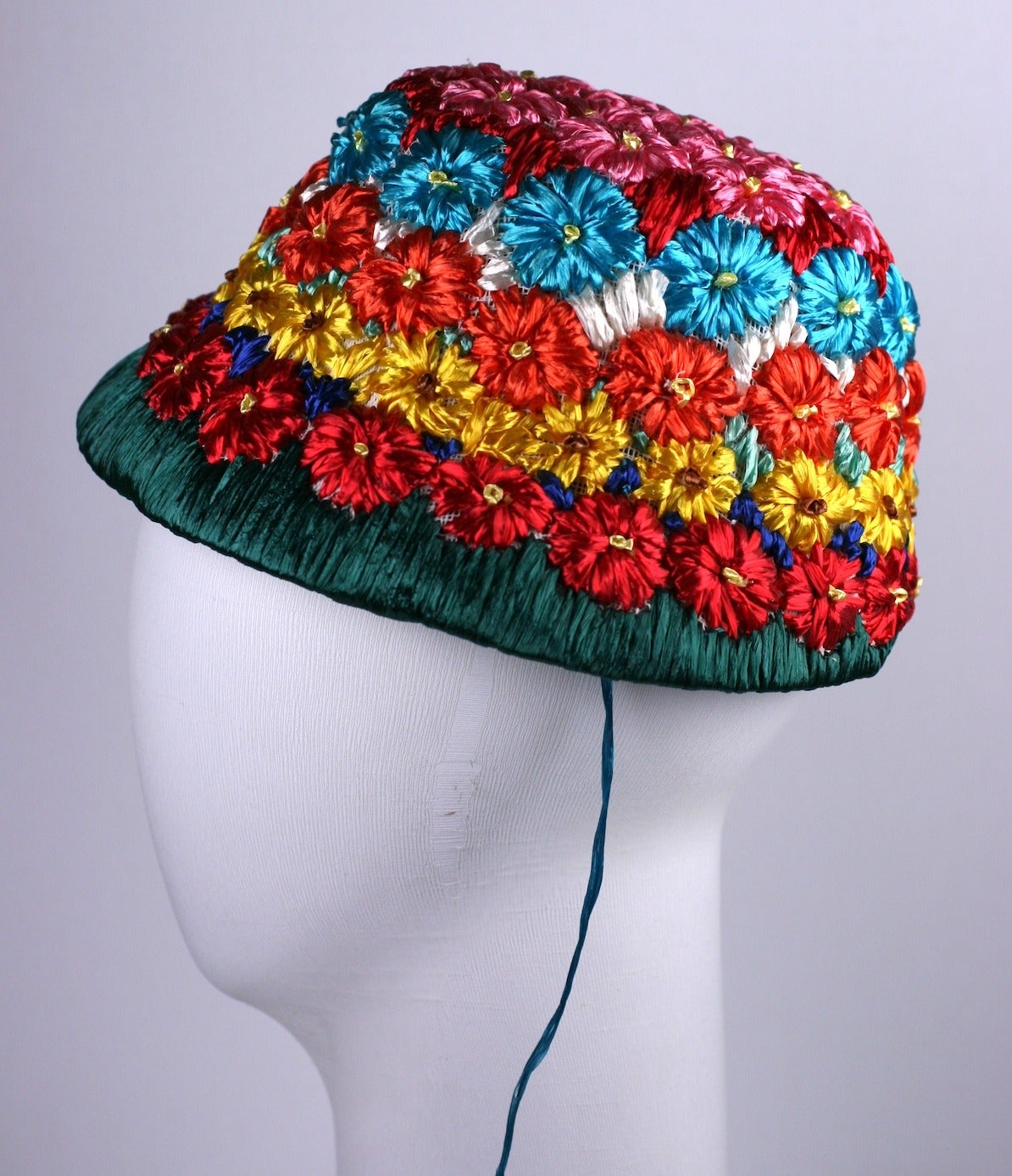 Charming Italian Raffia Bucket Hat with vibrantly toned flowers which graduate from hot pink to deep grass green at brim. 
Crown 3