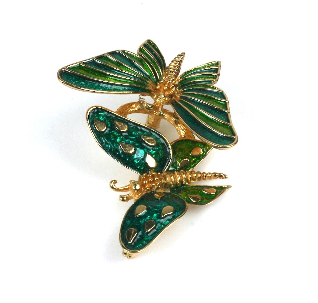 Boucher Enamel Trembler Butterfly Brooch in gilt metal from the 1970's. One butterfly (spotted) is stationary while the other is attached to a spring and 