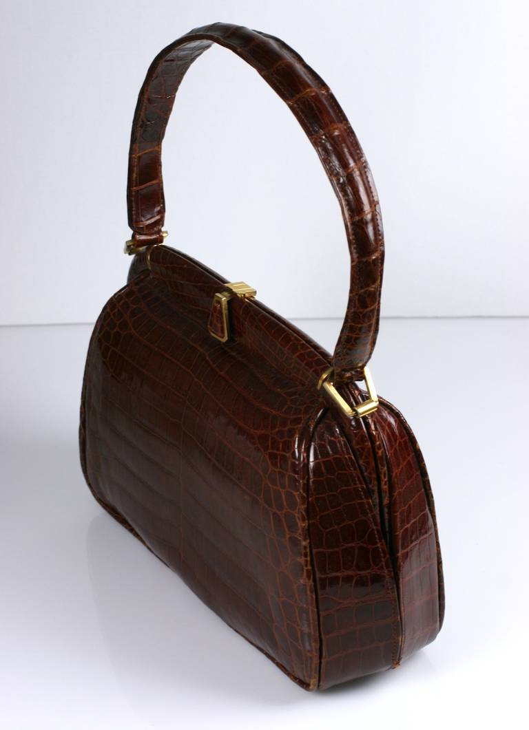 Attractive French russet brown alligator center cut bag by Josef, France. High quality manufacture and lovely modern style. Lined in calf. 1950's France. 
Body; 11