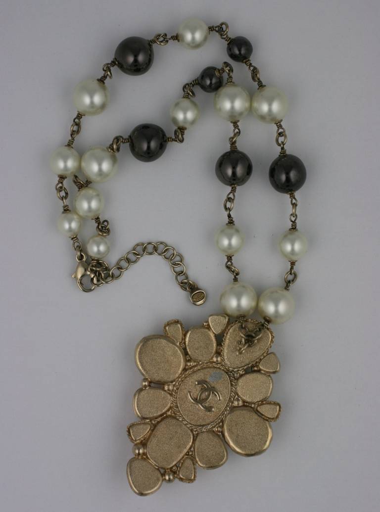 Chanel pendant necklace with cruciform pendant on hand wire wrapped pearls.
Classic Chanel tones of beige, ivory and black. Enamel pendant with black and ivory faux pearls of differing sizes. Marked 2008 France.
Pearls Handwired 19