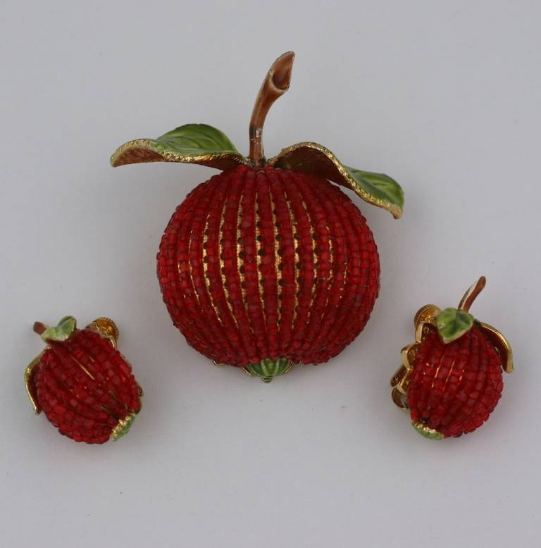 Unusual hand beaded "Apple" suite by Vendome. High domed gilt findings are wired with rows of ruby glass seed beads and accented with enamel leaves. Clip back fittings on earrings. 1950's USA. 
Excellent condition. Brooch 2" x