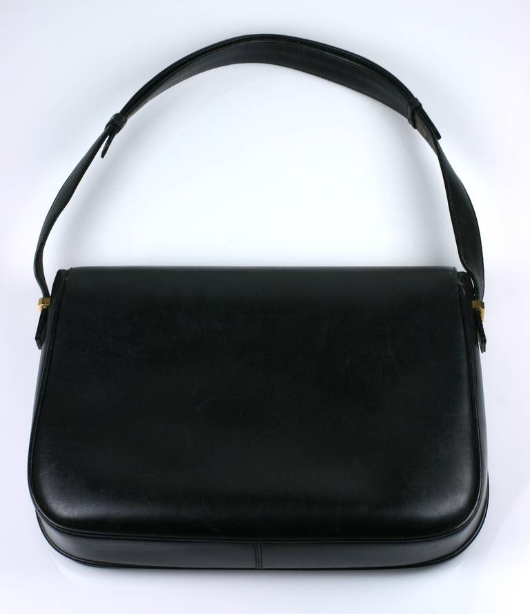 Elegant vintage black Gucci leather bag with convertible strap. To open, pull up on enameled Gucci 