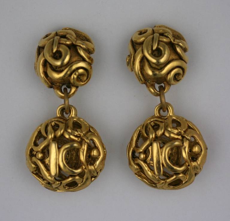 Large and ornate 1980's gilt earrings by Kalinger, Paris. Twisted gold motifs form a logo 