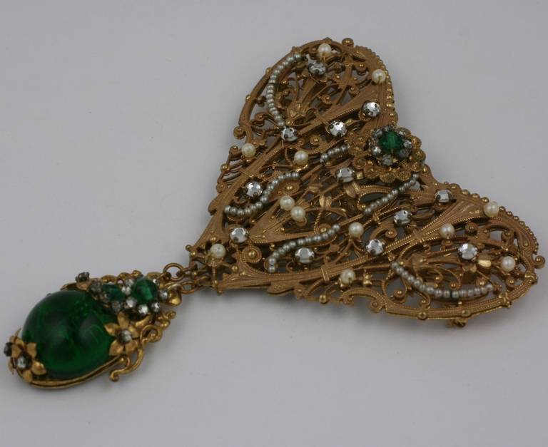 Miriam Haskell opulent 18th century inspired stomacher style large brooch of faux emerald pate de verre cabocheons , vari sized pearls and crystal pastes.The brooch  assembled of signature Miriam Haskell Russian gold filigrees. Excellent