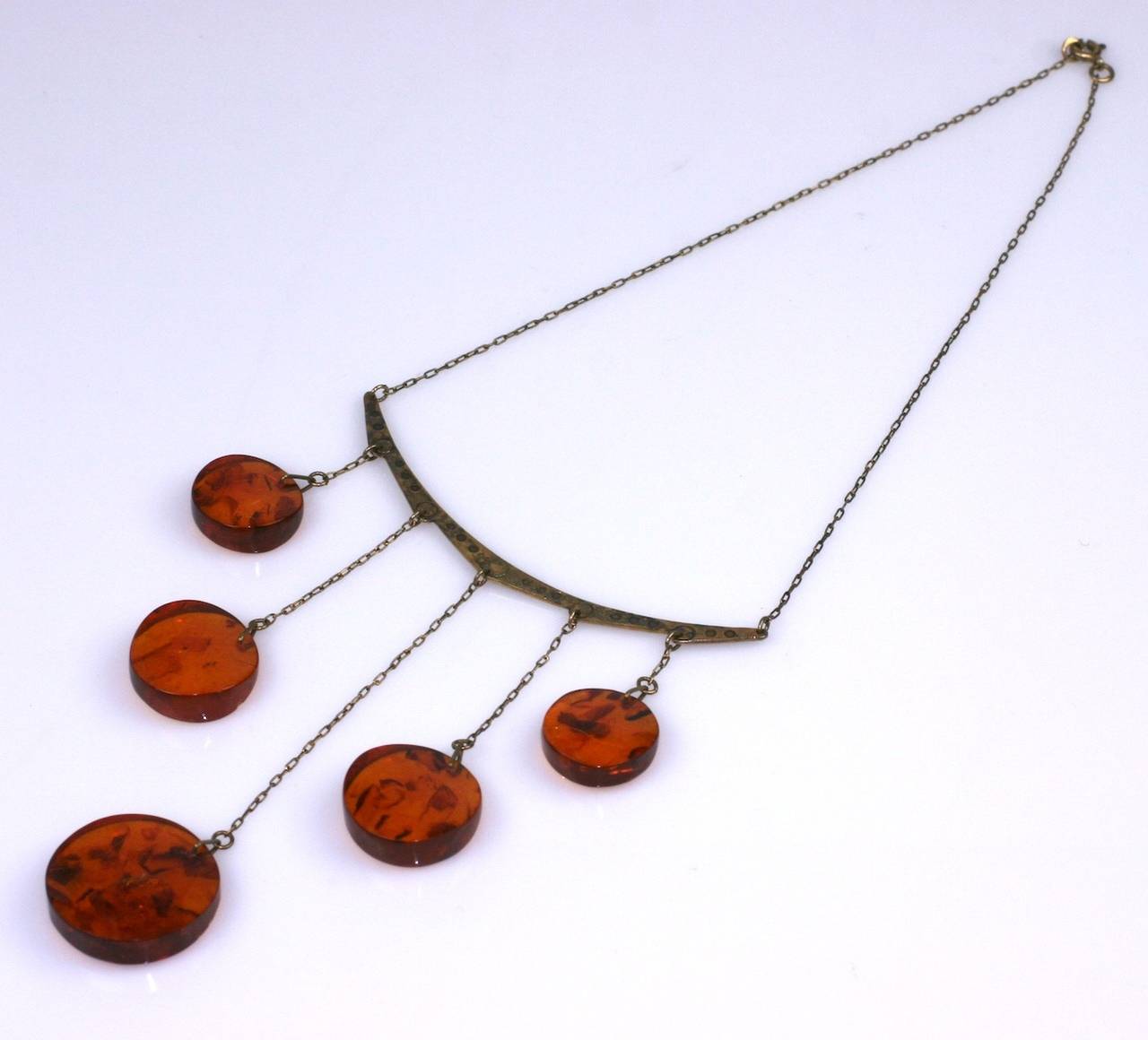 Amber Drop Modernist style necklace in gilded silver with chunky, graduated amber drops with natural inclusions. The metal necklet has circle decoration incised as well. Made of .875 grade silver with a gold wash, 1970's Russia. Excellent condition.