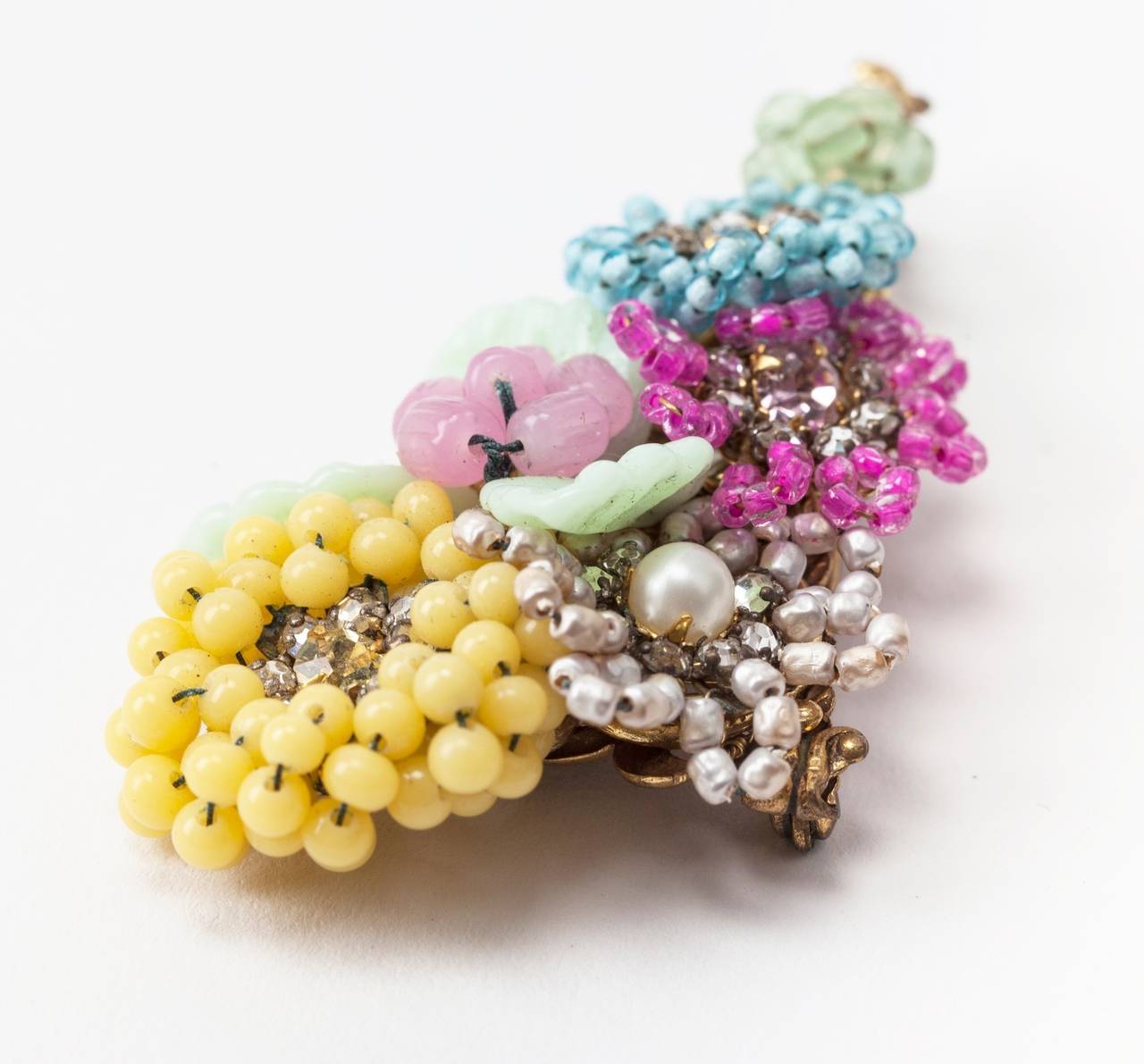 Miriam Haskell intricate multicolor pastel floral Spray brooch. A masterpiece of hand sewn pate de verre round and seed beads, freshwater faux pearls, crystal rose montes  and lampwork glass leaves set on signature Russian Gilt filigree base. Early