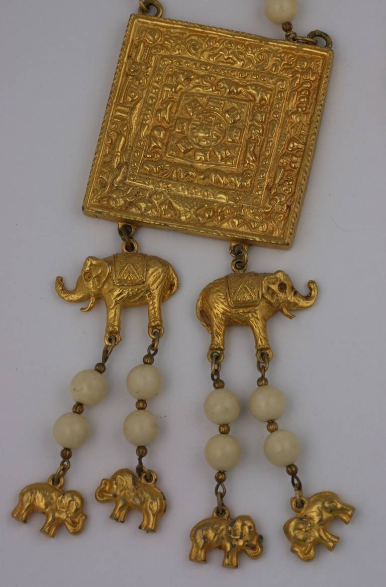 Charming pendant necklace from the 1960's by Jules Van Rouge. Faux ivory beads are spaced with gilt connectors and dangling elephant charms. 
20