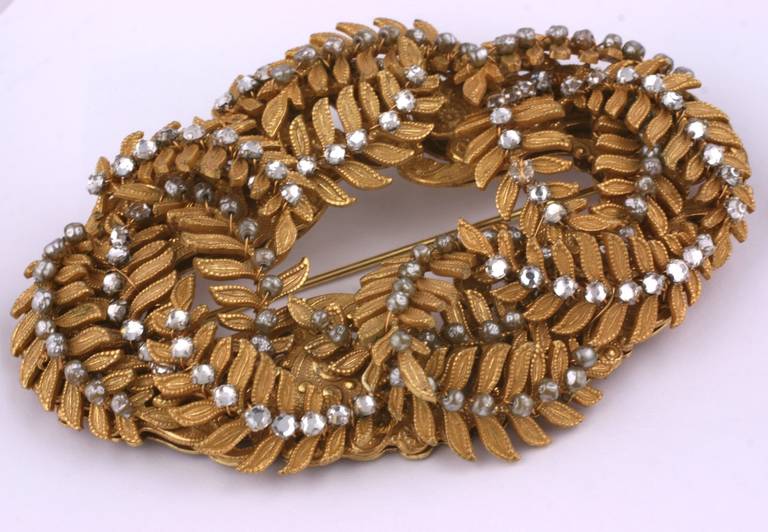 Miriam Haskell's 3 dimensional fern fronds motif massive brooch set in signature Russian gilt. The spines of each fern are hand sewn with crystal rose montees faceted stones. 1950's USA. Excellent condition.