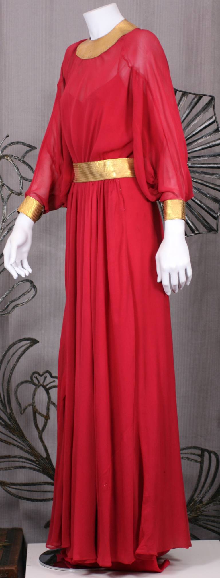 1930's Jeanne Lanvin vibrant red silk chiffon gown with signature trapunto topstitching on supplest gold kid leather. 
Elegant styling with full balloon sleeves and full circular skirt. One piece gown with gathered full skirt falling from waist.