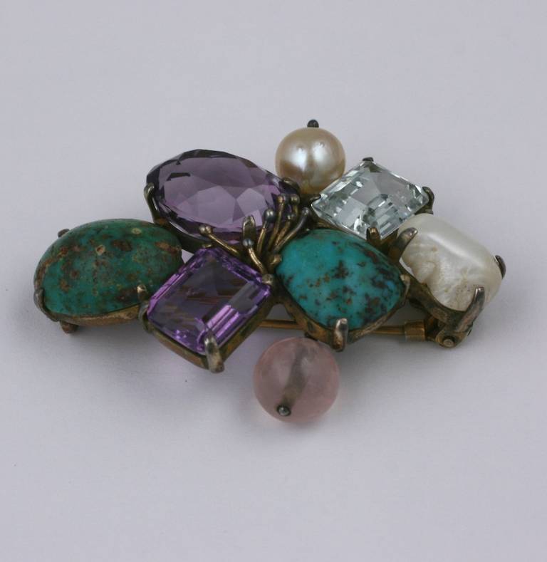 Artisan handmade gemstone clip of genuine semiprecious stones with large amythests, turquoises, aquamarine, rose quartz and pearls. Set in gilded silver. 1950's USA. 2.25
