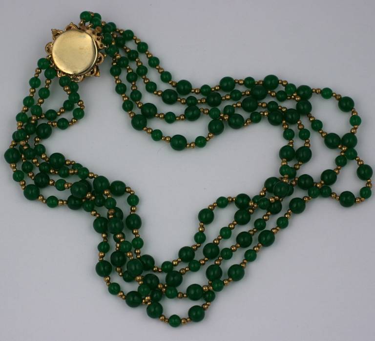 Haskell style graduated pate de verre emerald bead necklace with coral and paste gilt leaf decorated clasp. Mostly likely produced by the 