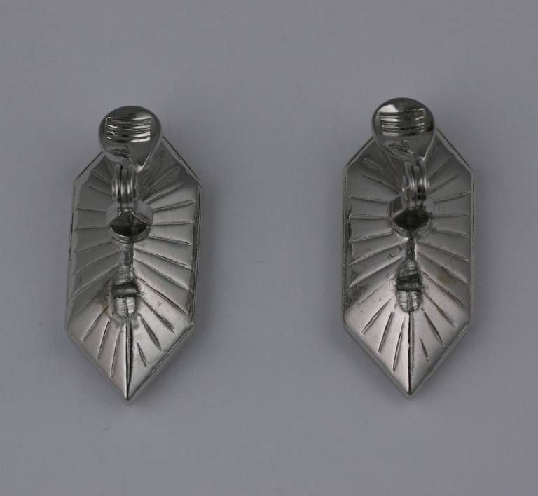 Striking Yves Saint Laurent earrings of one oversized pointed crystal baguette set in silver toned metal. Clip back fittings. 1990's France. 1.5