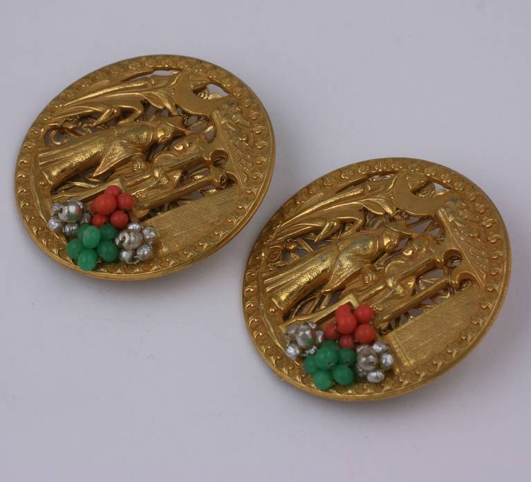 Miriam Haskell's pair of chinoiserie brooches depicting medieval chinese figures in a palace landscape. Of siqnature Russian gold plate further embellished with faux coral, jade, and baroque pearls.
1.75