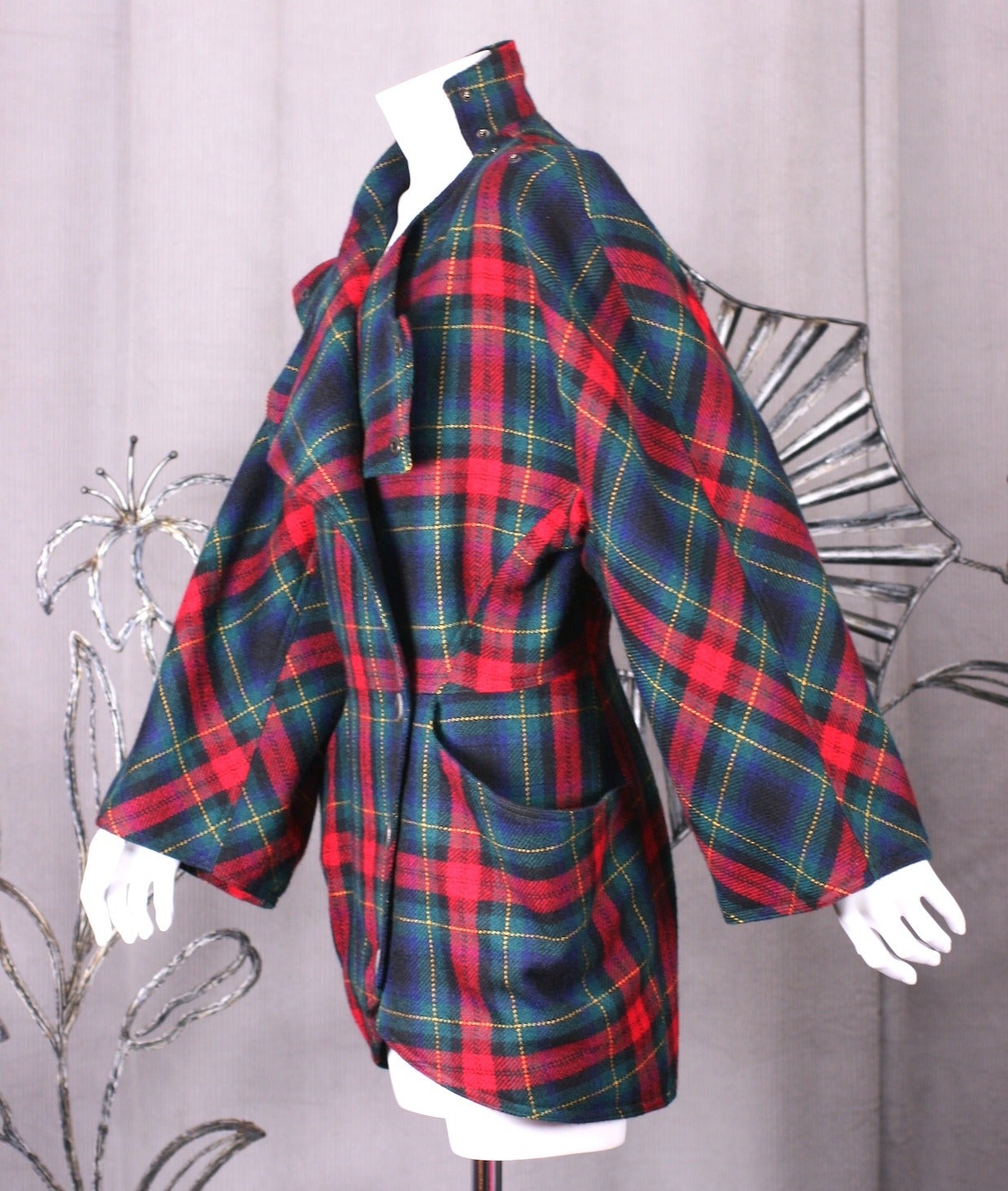 Anne Marie Beretta Fitted Plaid Jacket in Scottish tartan tweed. Beautifully cut with signature faux horn snap closure detailing. Large kimono sleeves, fitted waist and exaggerated hip pockets which wrap front to back. Asymetrical closure can be