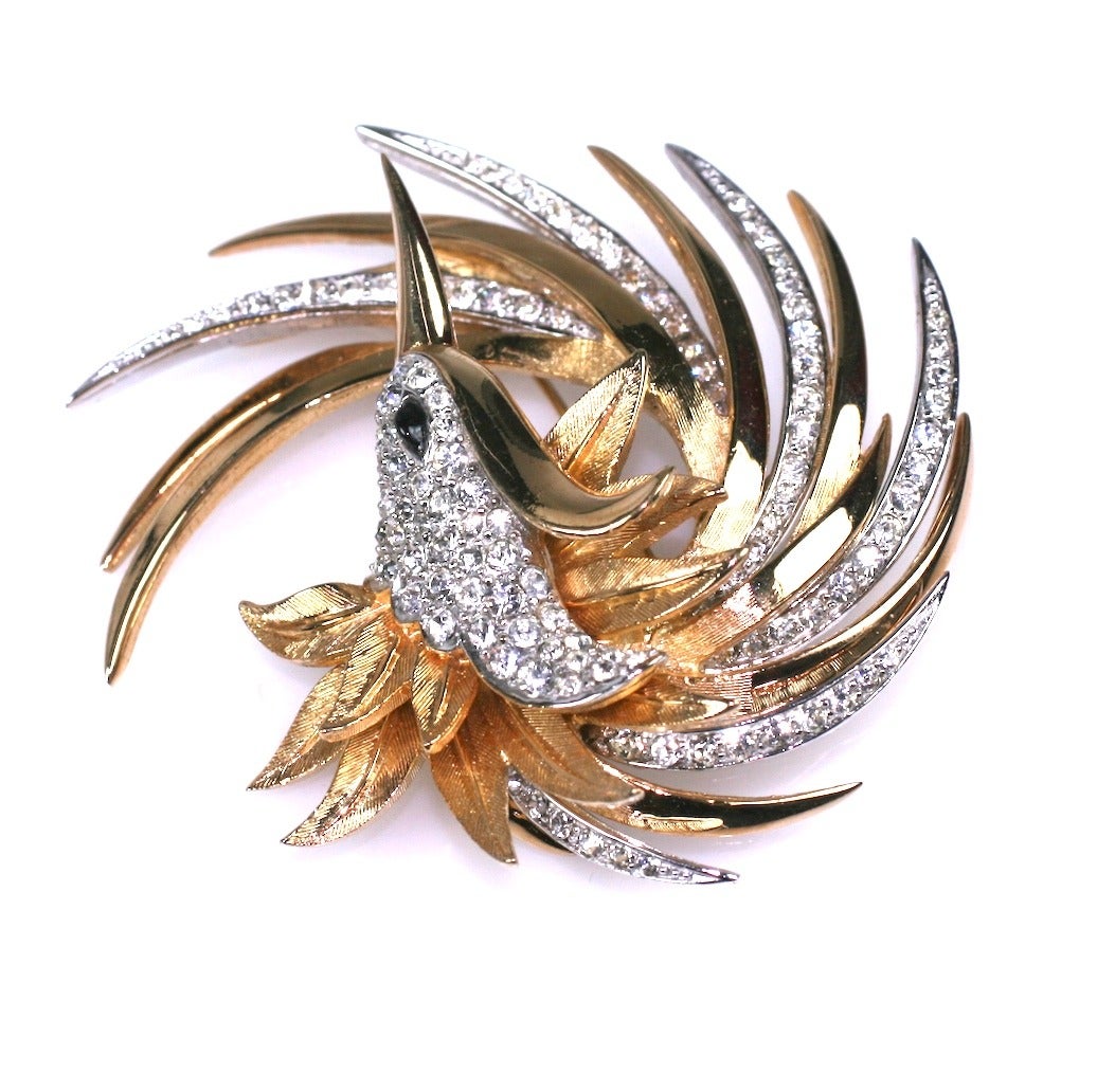 Marcel Boucher Abstract Swirled Bird Brooch rendered in gilt and white metal. The brooch is large and dimensional with movement from its design. The gilt metal areas are textured while the white metal areas are accented with crystal pastes. A