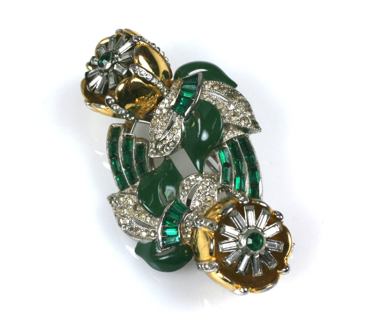 Coro classic flower twist tremblant duette brooch of gilt metal, green enamel,  rare emerald crystal baguettes and crystal pastes. Both flower clips separate off base to be worn separately. 1940's USA. Excellent condition. 
Length  3