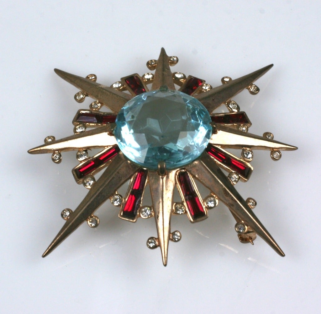 Trifari 1940 retro style gold washed sterling silver starburst comet brooch. Large faceted faux aquamarine ,faux ruby baguettes and crystal pastes. 1940's USA. 
W 1.75