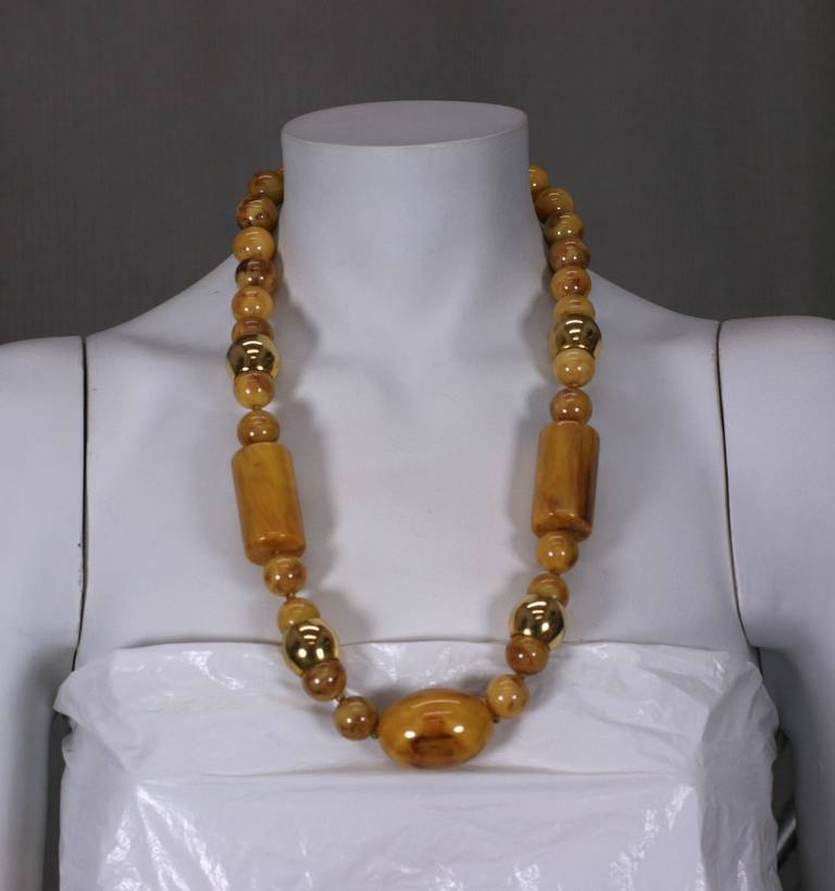 Large necklace of variform beads in end of day caramel bakelite with gold bead spacers. 1970's Italy.  Excellent condition. 
Length 26