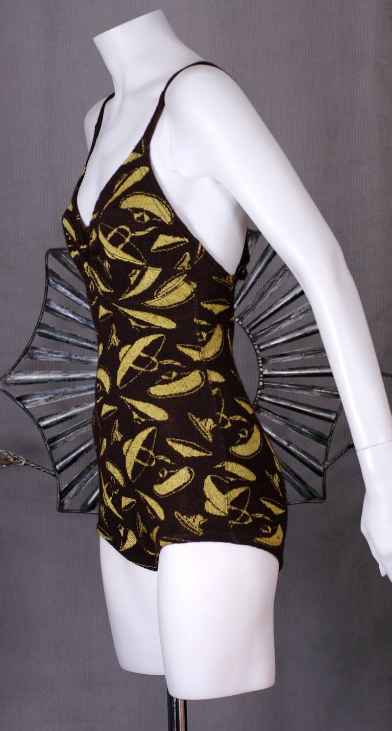 Art Deco Swimsuit with flying sun hats, sombreros or saucers?! in very Art Deco yellow-chartreuse on a brown knit ground. Charming Art Deco motifs with front lacing detail and back cross straps. Label by Jantzen Original, Patent Sept. 1921. Likely