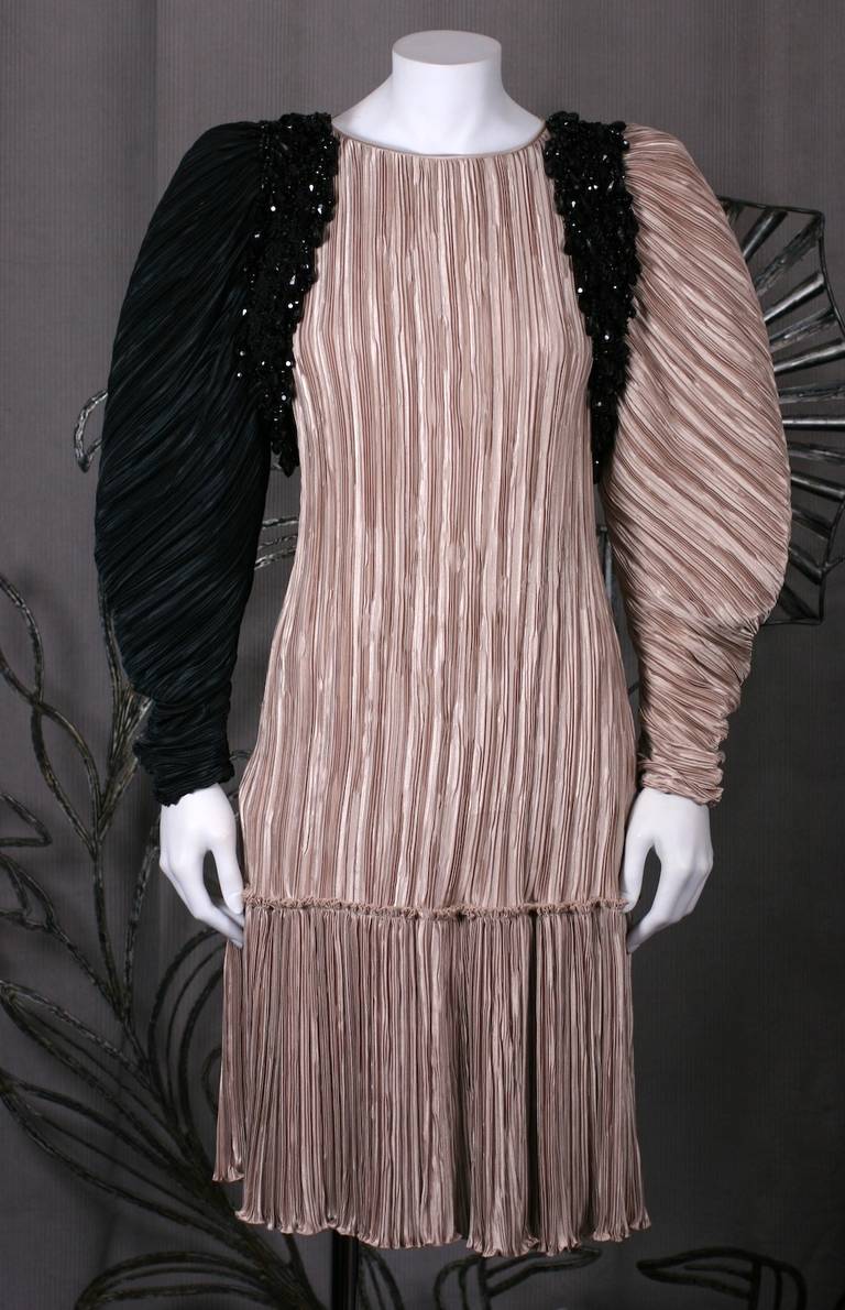 Mary McFadden's cafe and black pleated cocktail dress with large gathered sleeves and a jet embellished 