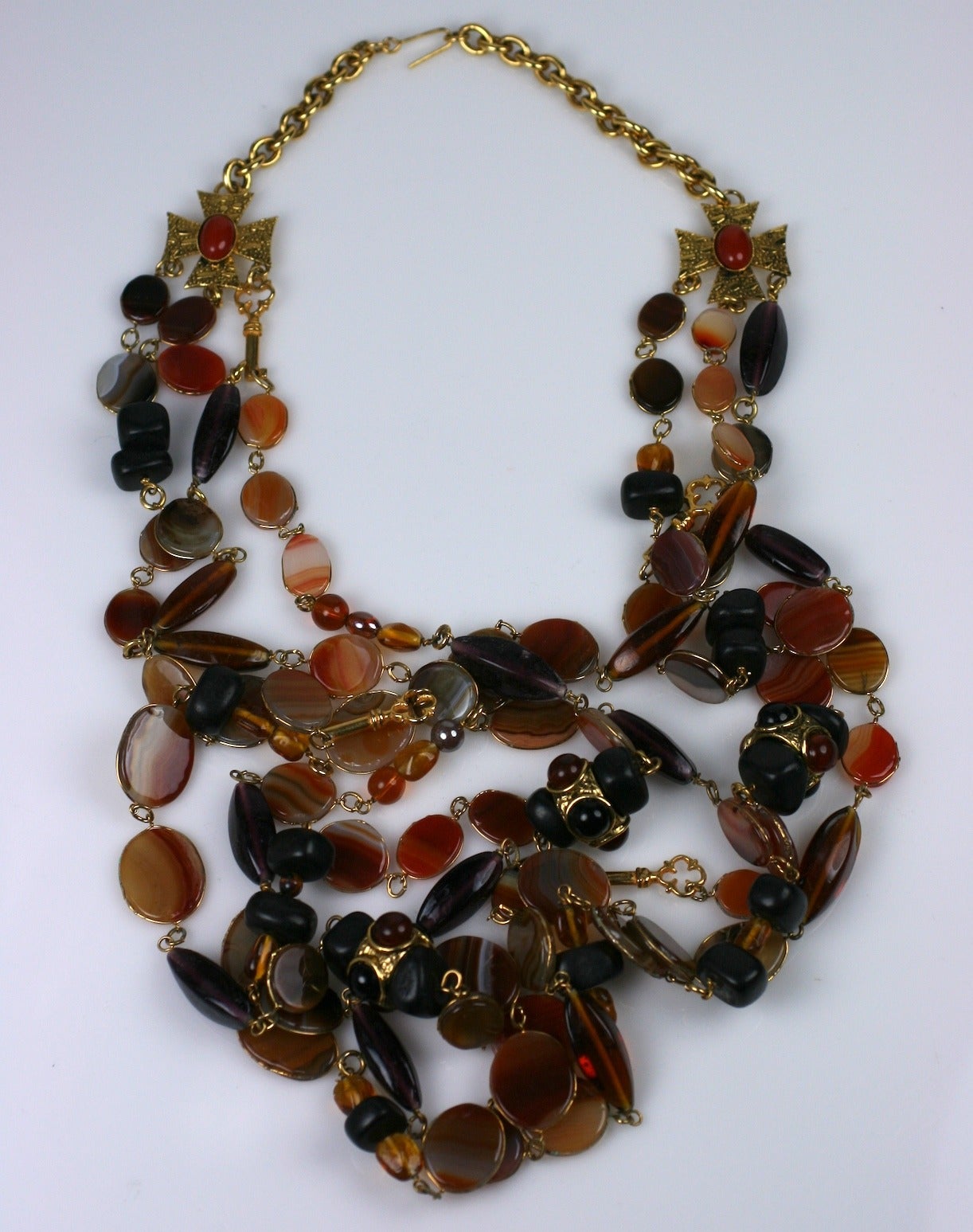 Phillipe Ferrandis' super long multi-strand necklace of bezel set genuine striped agates mixed with gilt keys and wood stations embellished with jet and amber pate de verre cabochons. All the strands hang from a pair of maltese cross stations