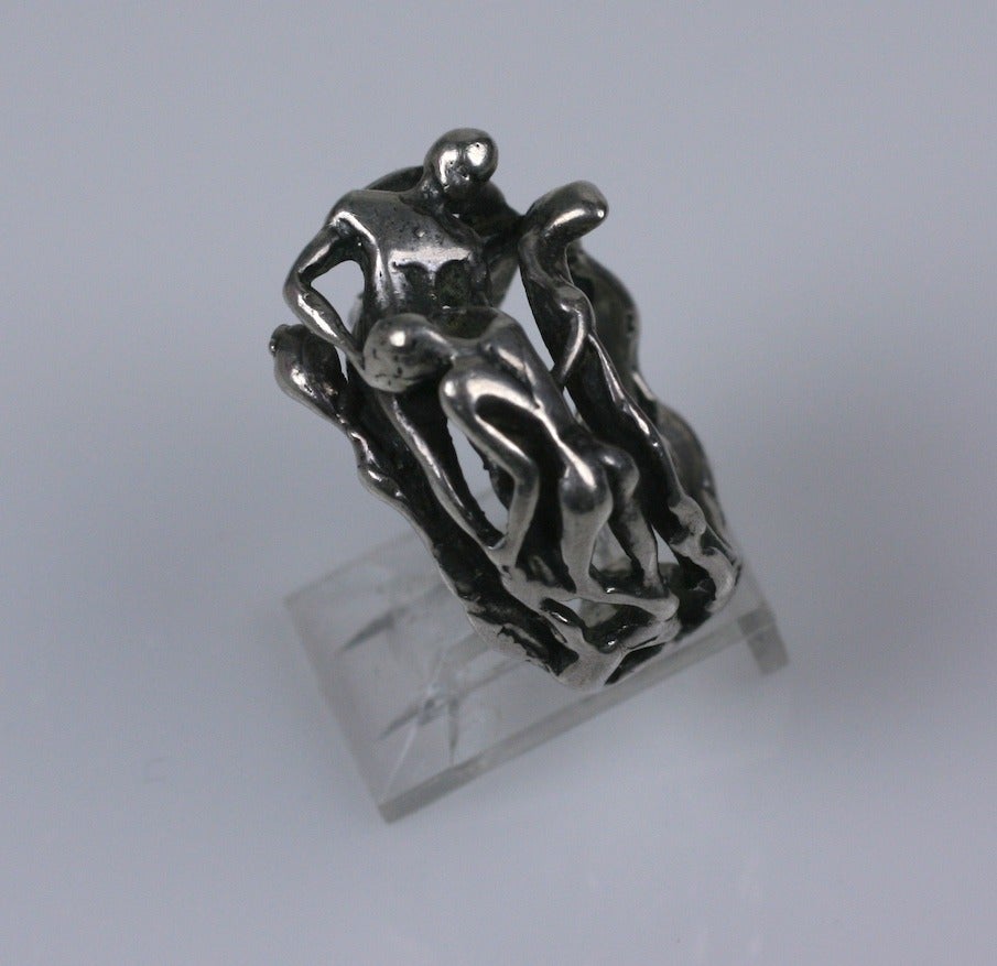 Adam and Eve in the Garden of Eden are depicted as 2 entwined figures surrounded by snakes in this sterling ring from the 1960's. Fine detailing which reveals itself around all sides of the ring. 1960's USA.
7.5 size. Excellent condition.