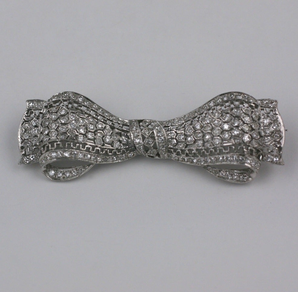 Attractive  diamond bow brooch set in 14k white gold, Delicate openwork throughout with a greek key border within the pave diamond honeycomb pattern. 
Very good looking and well valued . Extremely high quality. Carat weight approx 2 carats.
2.2