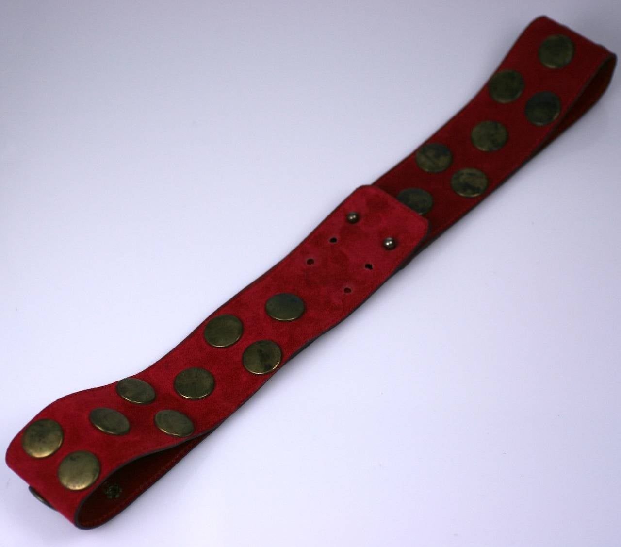 Early Sonia Rykiel brass studded red suede belt. Worn as a anchor for her oversized graphic knits. 1980's France. 
Adjustable 30-33
