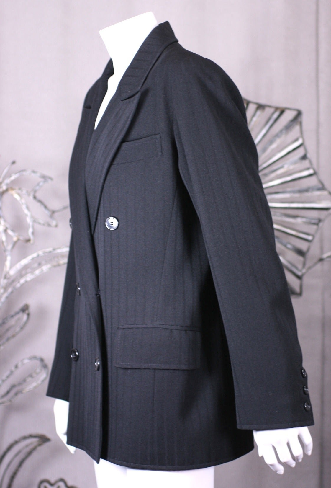 Yves Saint Laurent strong shouldered jacket of black wool whipcord with double breasted styling. Beautifully man tailored for loose fit, falling from strong shoulders. Fully lined, 1980's France. 
Size 40 Eu. 