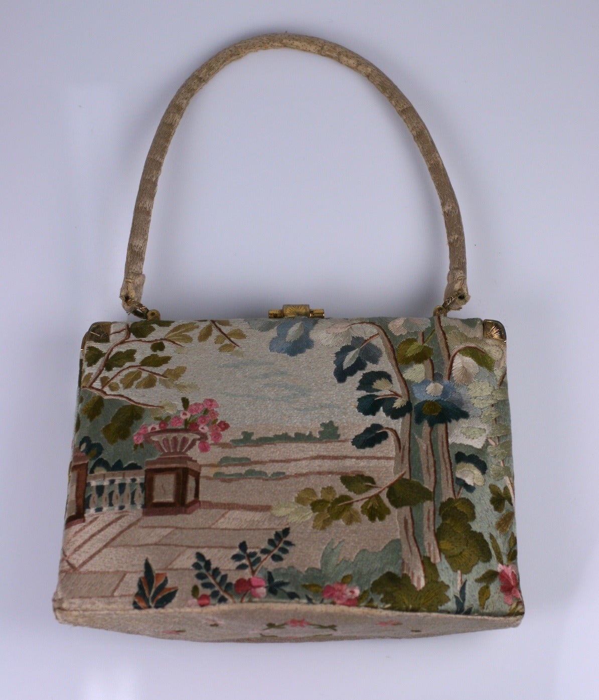 Charming french bag from the 1950's fully embroidered with silk floss on all sides includung handle. One side depicts an 18th Century courtesan scene and the other depicts a garden scene. Beautiful quality embroidery. 
8.5