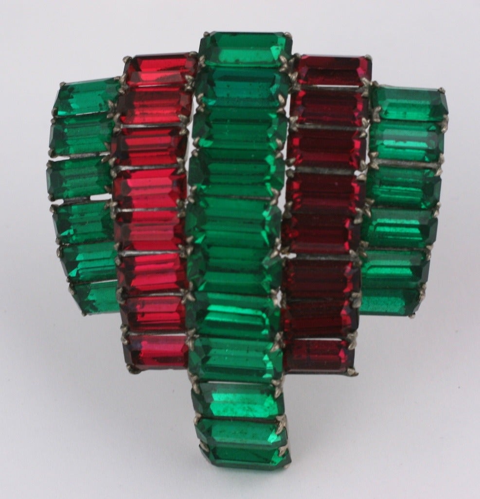 Large scale bombe faux ruby and faux emerald baguette dress clip brooch, 1950s.
Baguettes are set in layers for dimension. Possibly by Roger Jean Pierre.
Length 2.75
