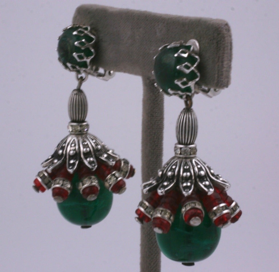 Schiaparelli earclips of antiqued silver gilt metal with faux emerald and ruby pate de verre beads and pave rondels in the Moghul style.
Schiaparelli was famous for her  reinvention of ethnic styles as seen in these earclips.
Note : An identical