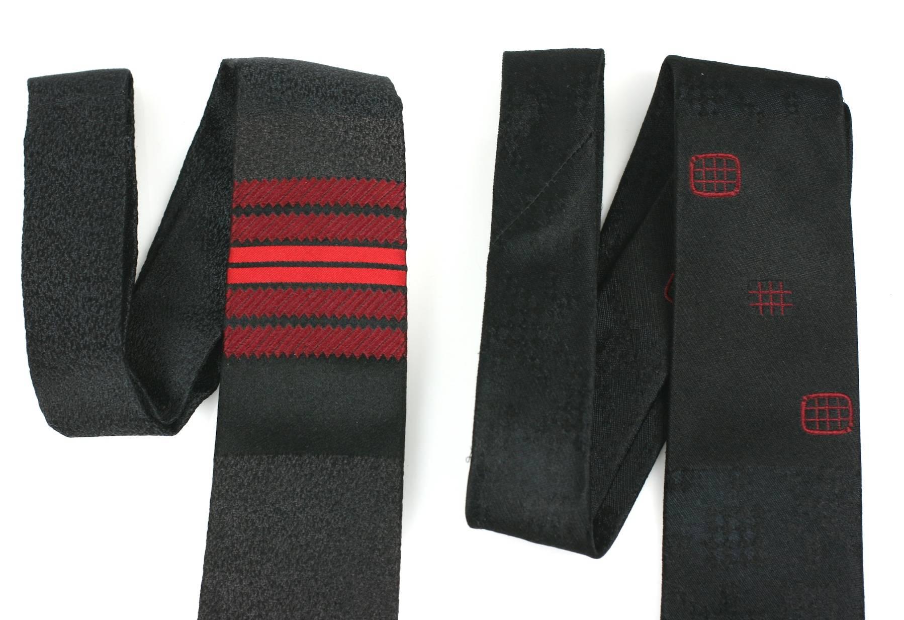 Jacques Fath Skinny Ties from the 1950's. Both are black, one heathered with marroon stripes, the other with subtle red Japanesque patterns. Great for men or women and perfectly suited for vintage Hedi Slimane as well as new YSL. Timelessly cool