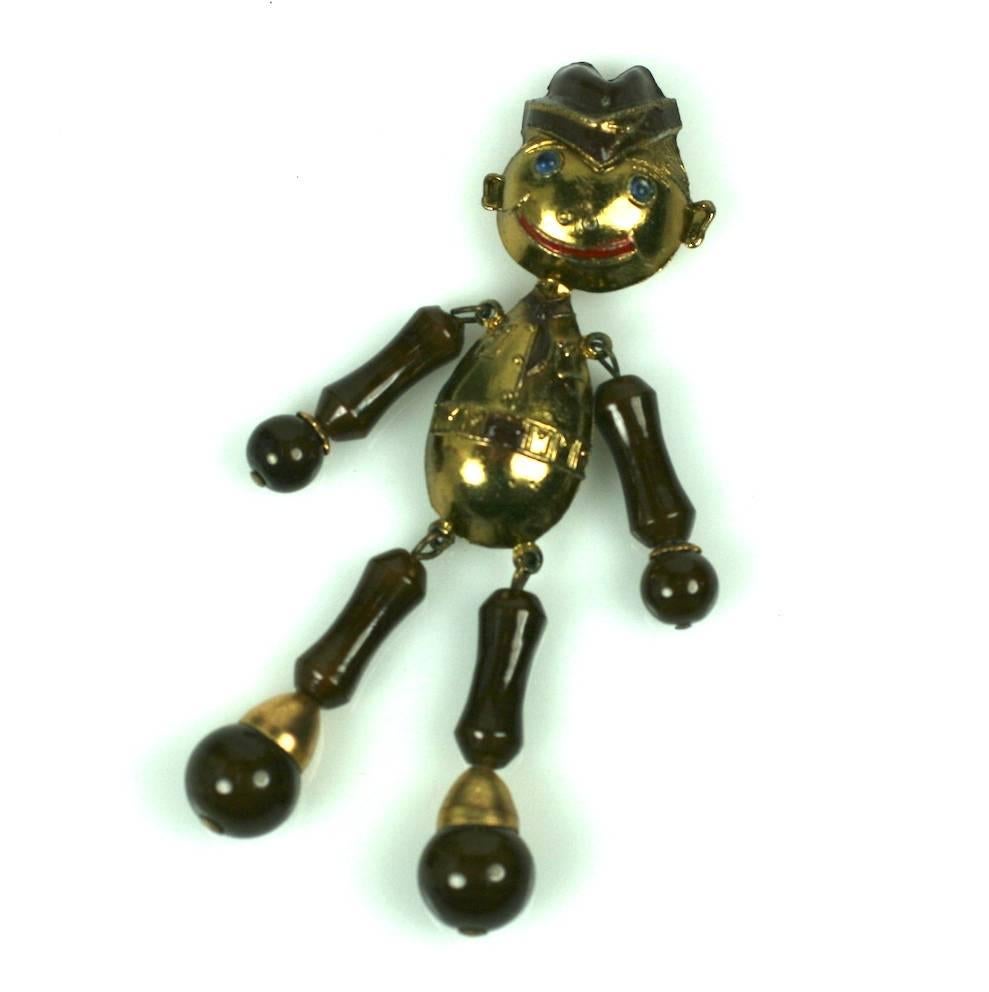 Charming Soldier Boy Brooch from the Art Deco Period. Composed of brown Czech glass beads and and molded gilt metal elements with enamel. He has a charming grin and blue cabochon eyes. 1930's USA. 4.25