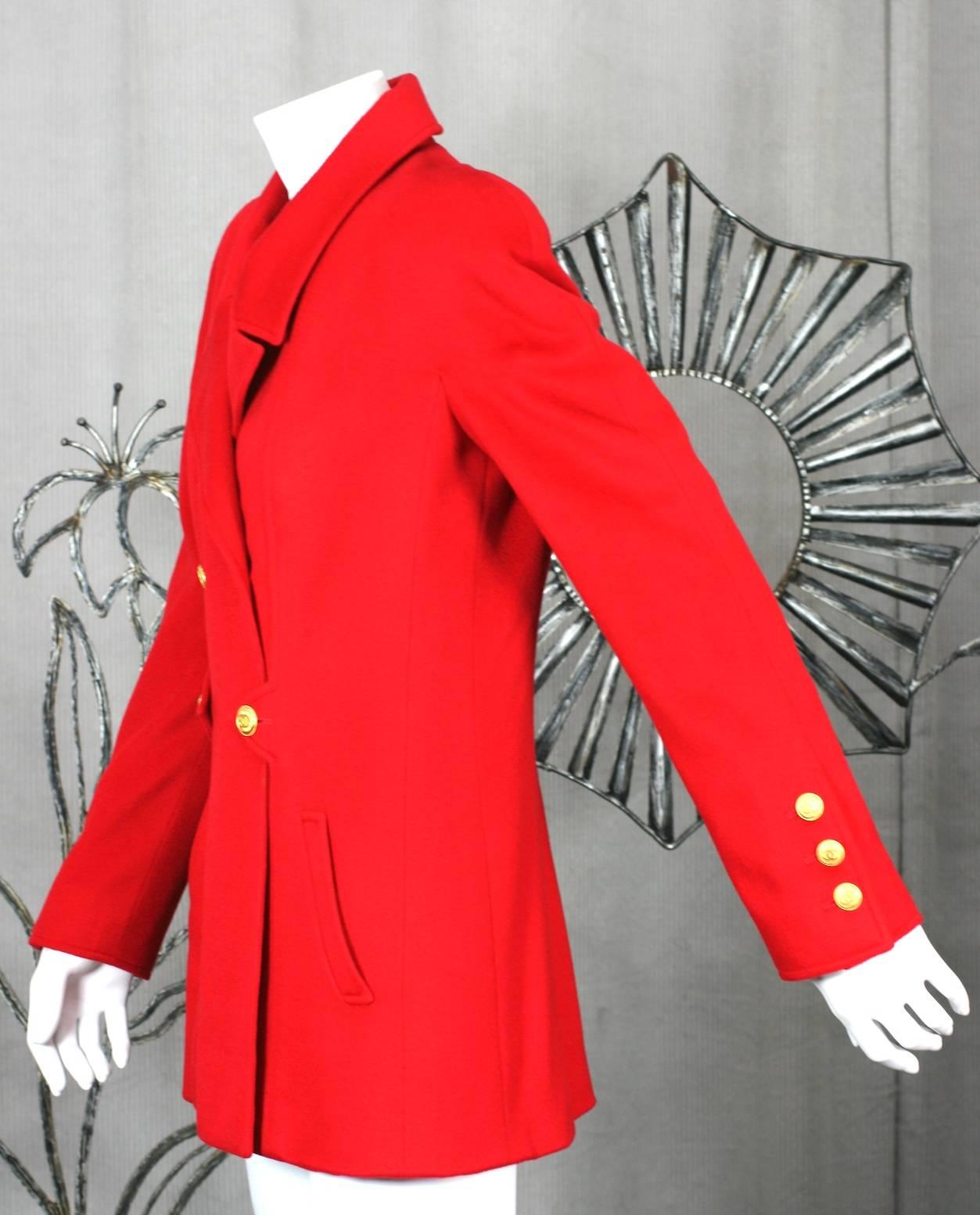 Chanel Red Cashmere Jacket by Karl Lagerfeld. Signature stand away collar with military detailing, gold logo buttons, slash pockets and tight sleeves falling from rounded shoulders. Hip length, fitted through waist. Silk logo lining. Size 38 Eu.