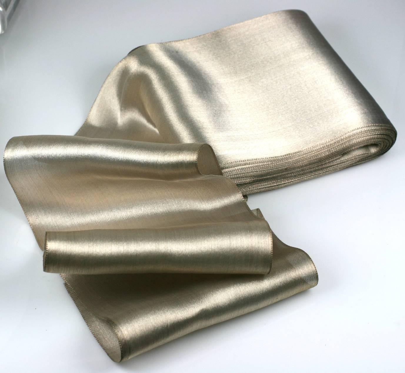 Old stock of period silk and metallic lame ribbon from France. This type of material is no longer produced and actually has metal content which when creased retains those lines, similar to what happens when metal foil is folded or crushed.
We were